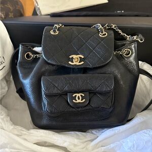 CHANEL Black Quilted Backpack with Gold Accents